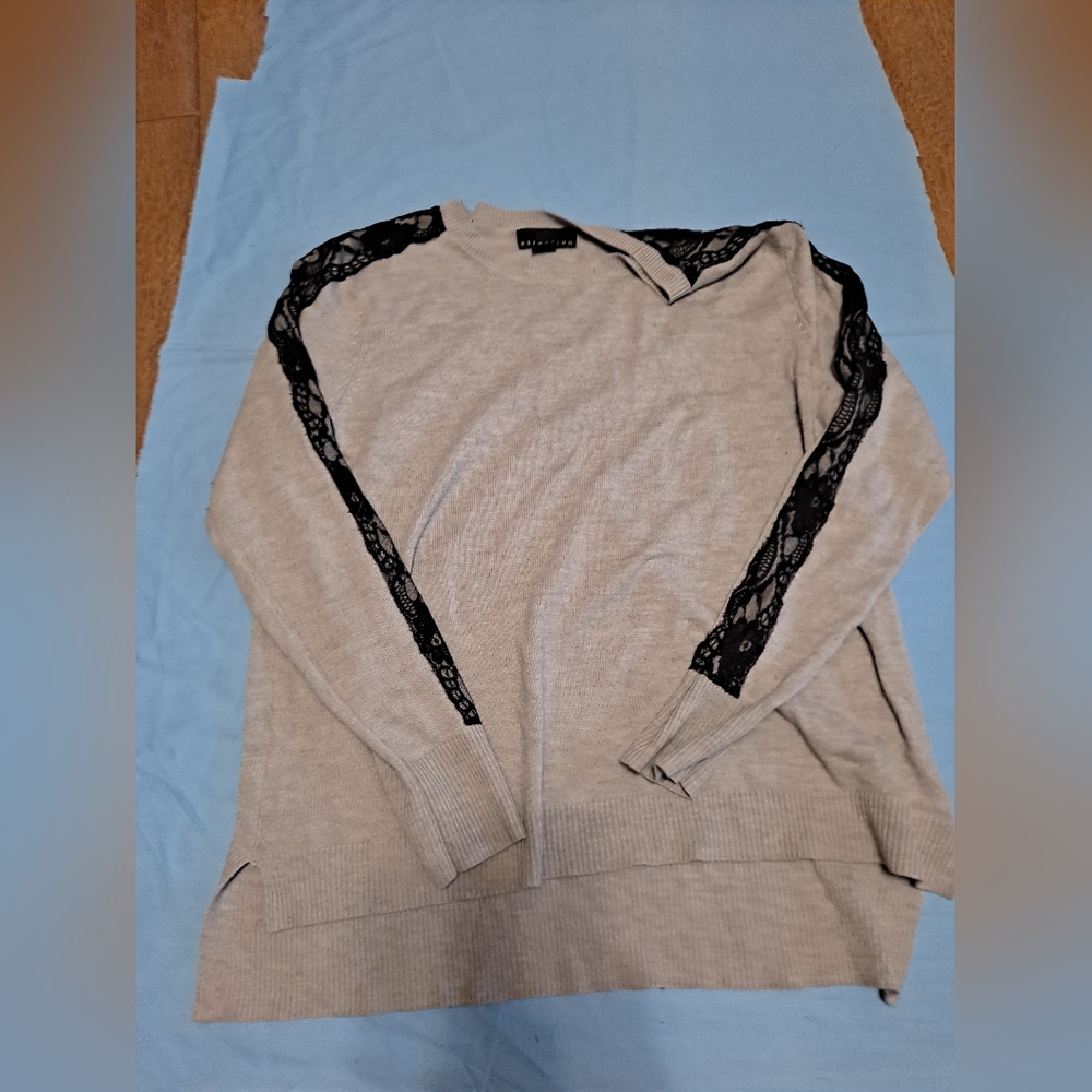 grey swetshirt with black lace fabric on the arms